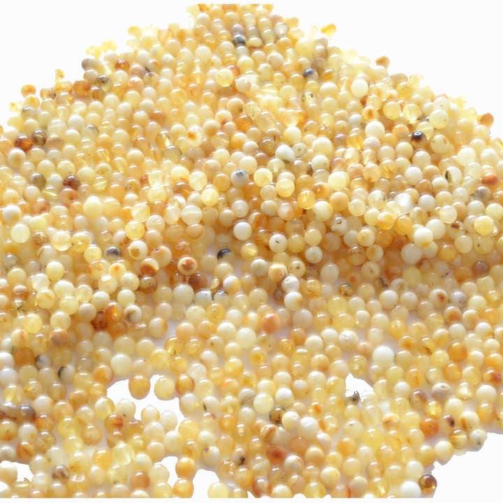 Loose Milky Round Polished Amber Beads for wholesale by The Natural Amber
