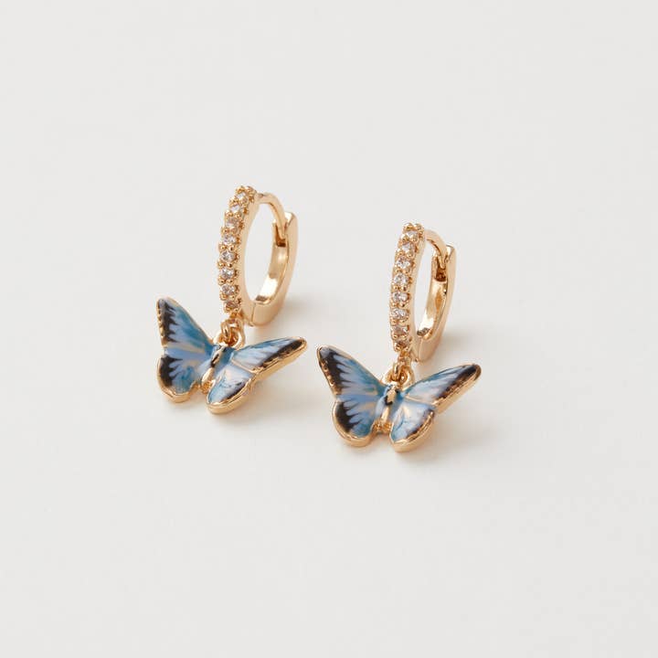 Fable England - Vente Petits anneaux - Boucles d'oreilles Huggie en forme de papillon bleu FABLE en émail