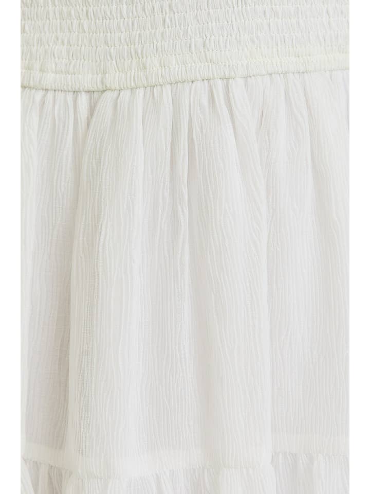 White SMOCKED TIERED MINI DRESS for wholesale on Faire