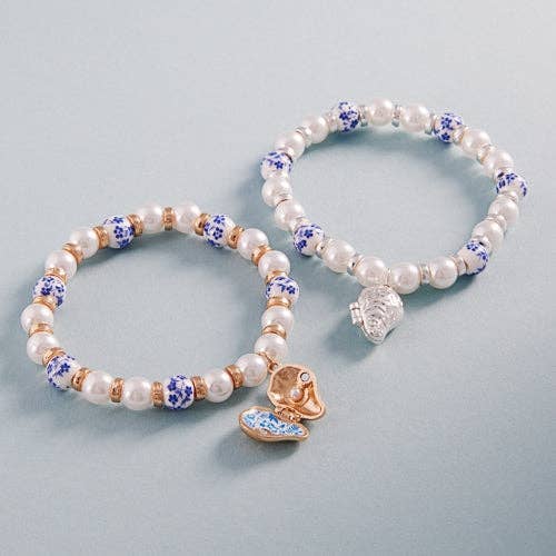 Bracciale elastico con perle di ceramica e ciondolo ostrica. per la vendita all'ingrosso da parte di Verita Lane