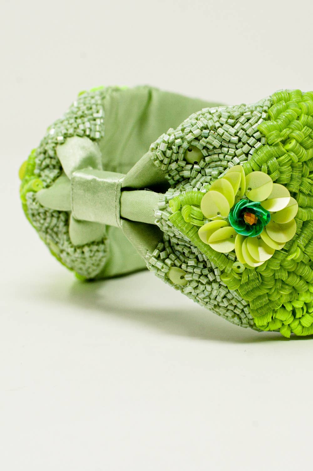 Chunky headband with embellished green flowers for wholesale on Faire4