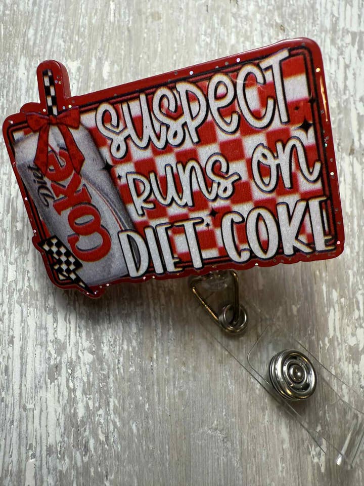 Badge ReeL Suspect only drinks Diet Coke for wholesale by The Wild Poppy