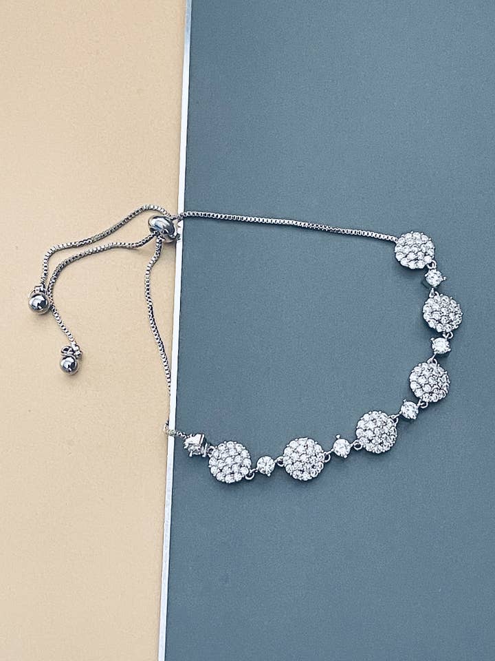 ROSELINE - Alternating Larger CZ Pave Rounds And Smaller Round CZs Adjustable Bracelet In Silver for wholesale by JohnnyB Jewelry