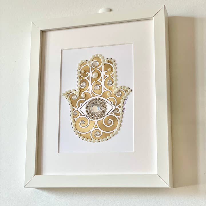 Gold Hamsa Framed Print for wholesale by Russell Jeffery Design by Off By Heart Design