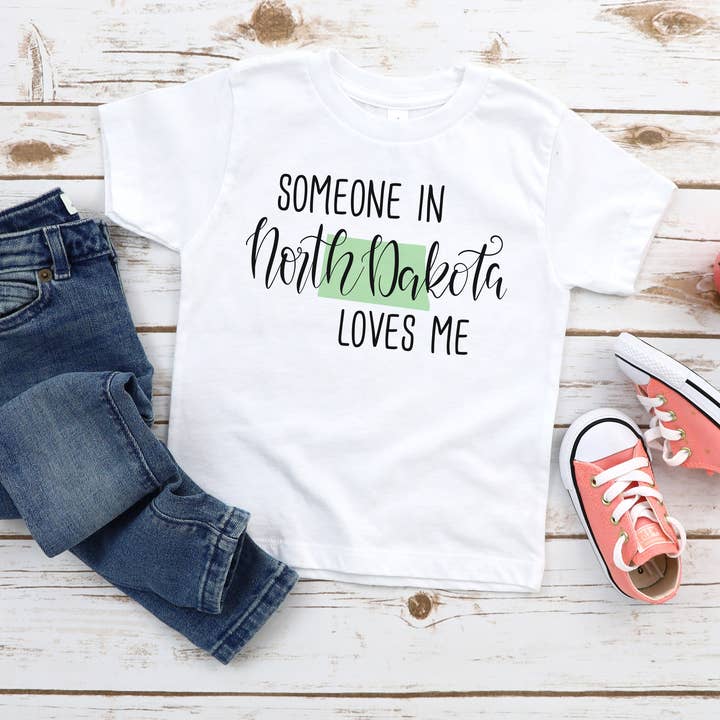 Someone In North Dakota Loves Me Toddler and Youth Shirt for wholesale by Itsy Bitsy Bella Co