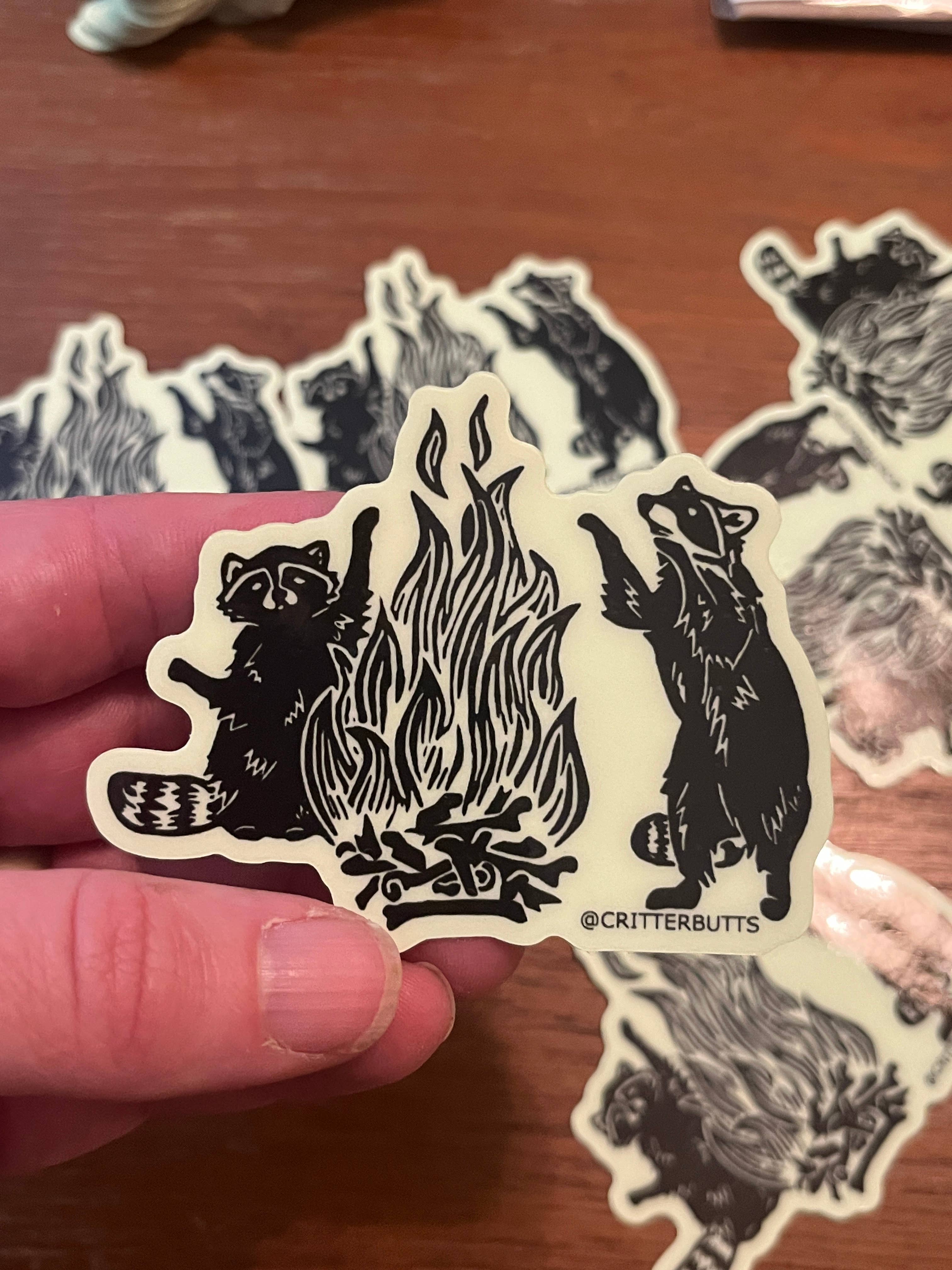 Critter Butts - Wholesale Phone & Laptop Stickers - Glow in the dark Raccoon Bonfire Sticker