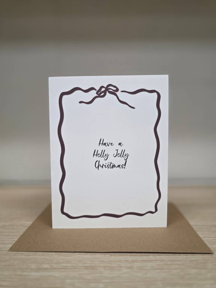 Holly Jolly Christmas Bow Frame Greeting Card for wholesale by Covered With Art