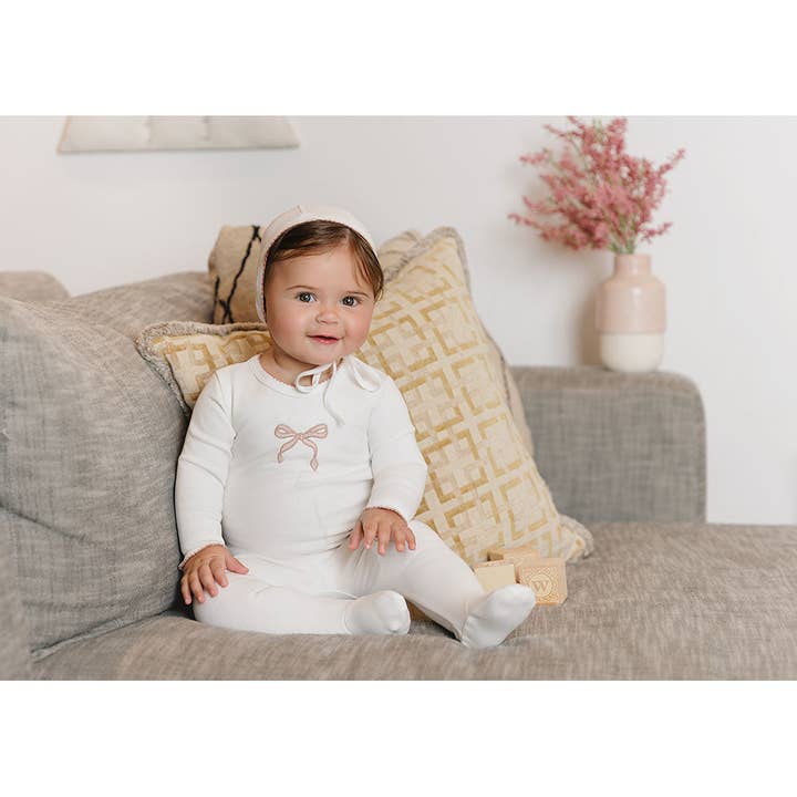 Ivory Pink Bows & Kisses Footie for wholesale on Faire2