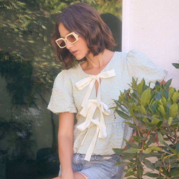 BUBBLE PEPLUM TOP WITH TEXTURED FABRIC AND BOW for wholesale by idem ditto