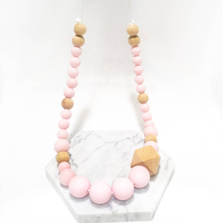 Tandningshalsband i silikon och trä - rosa för wholesale av Irréversible