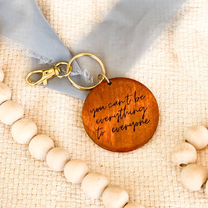 You Can’t Be Everything to Everyone Wooden Engraved Gold Keychain for wholesale by The Joyful Bee Co