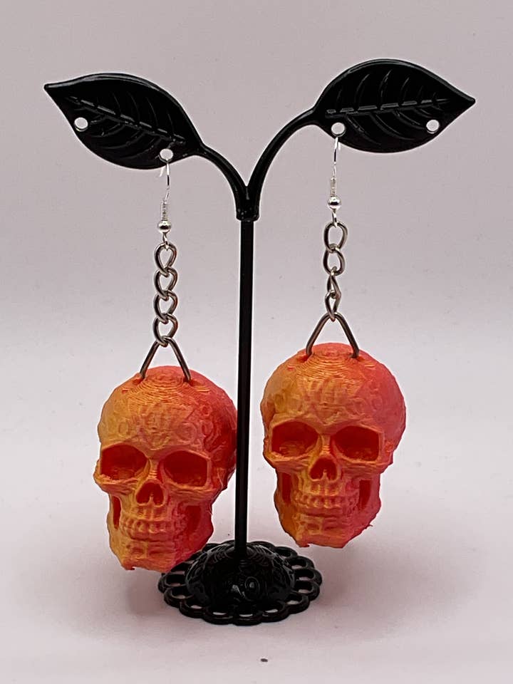 Orecchini a forma di teschio arancione per la vendita all'ingrosso da parte di S and E Hobbies and Collectables