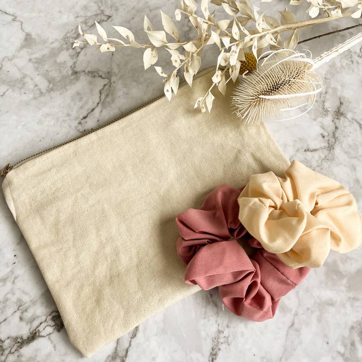 Cosmetic bag in cream white with two pink scrunchies for wholesale by shopandmarry