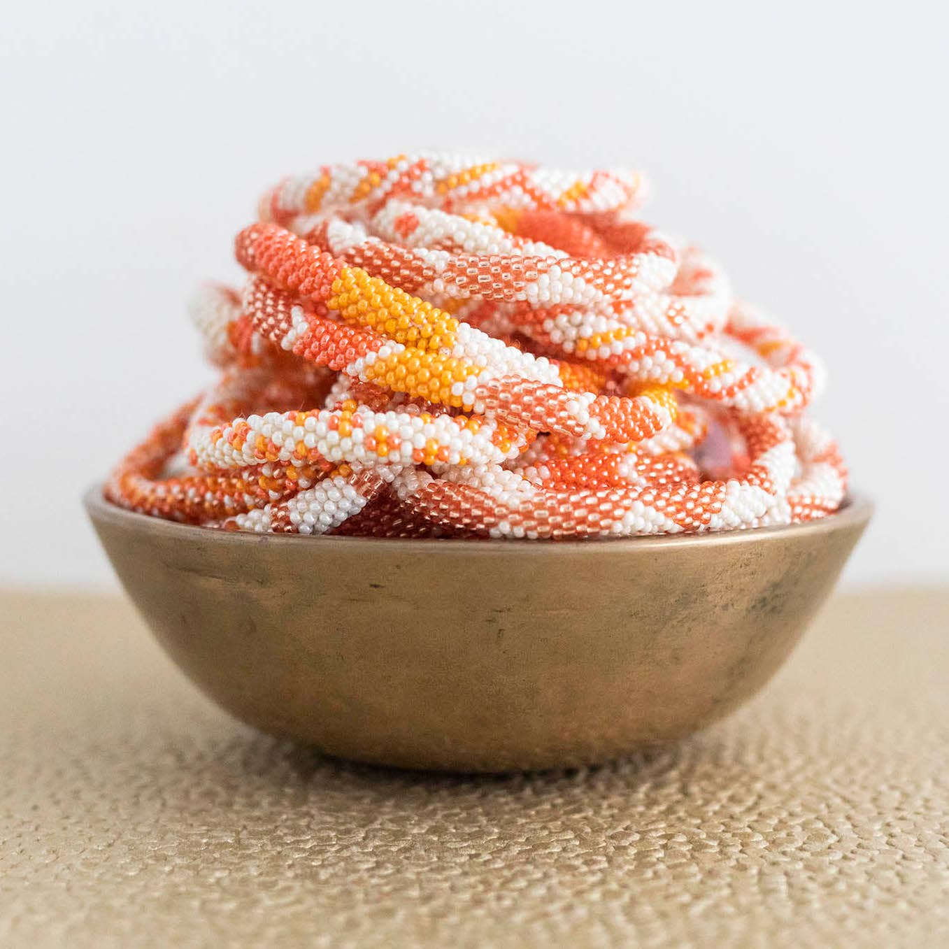 Aid Through Trade - Wholesale Jewelry Set - The Original Roll-On® Bracelet Tangerine - Set of 121