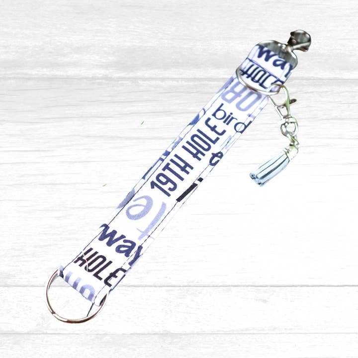 Llavero tipo pulsera de golf en blanco y negro con barra y borla para venta al por mayor de Kimmi Jo