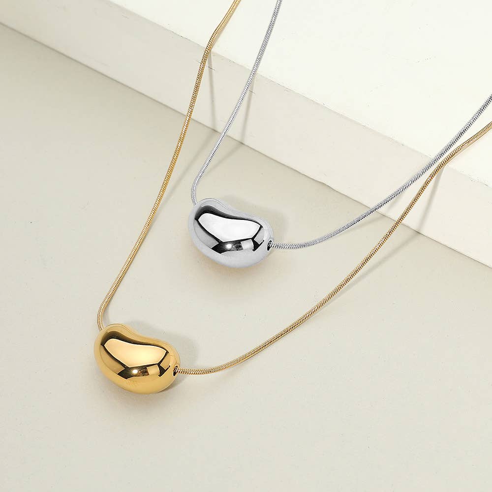 Sensibling Corp. - Venta al por mayor Collares con colgantes/abalorios - Collar con colgante de frijol de acero inoxidable bañado en oro de 18 quilates0