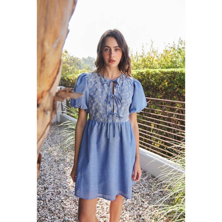 CHAMBRAY EYELET BUST MINI DRESS WITH FRONT BOW TIE DETAIL for wholesale on Faire
