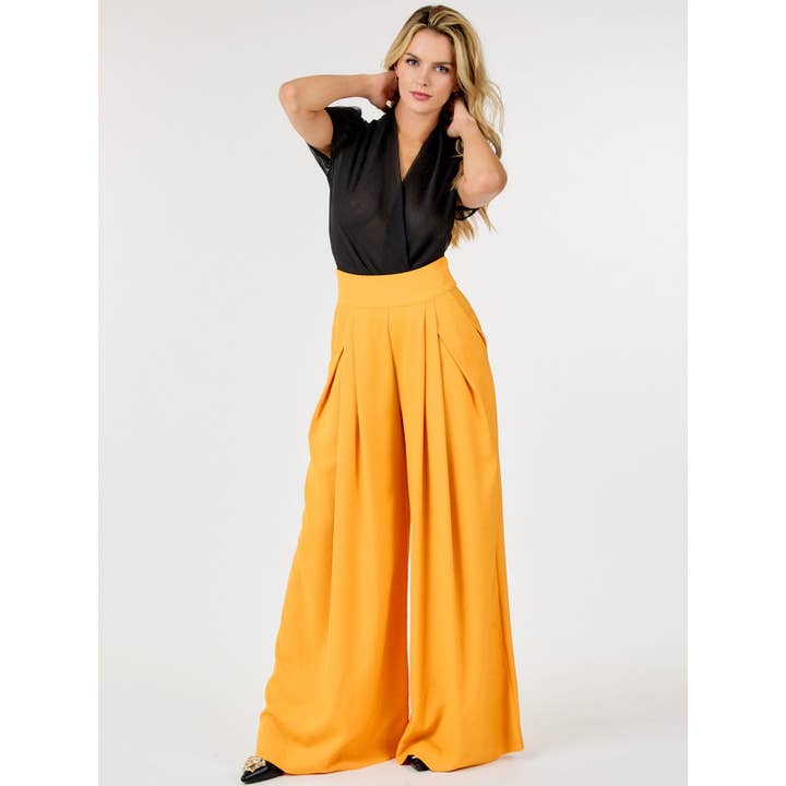 PANTALON LARGE À FERMETURE ÉCLAIR ET POCHES PLISSÉES SUR LE DEVANT pour la vente par IWT Brands