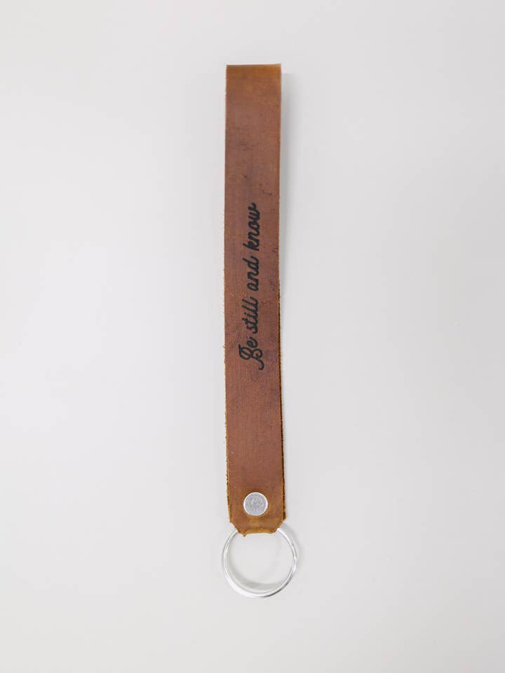 Be Still And Know Wristlet Engraved Leather for wholesale by Jubilee Trading Co. | Ethical Trade Decor + Accessories