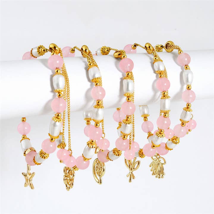 Pulsera ovalada de plata clara con perlas doradas y perlas de color rosa claro en diferentes dijes hawaianos para venta al por mayor de S&T Collections