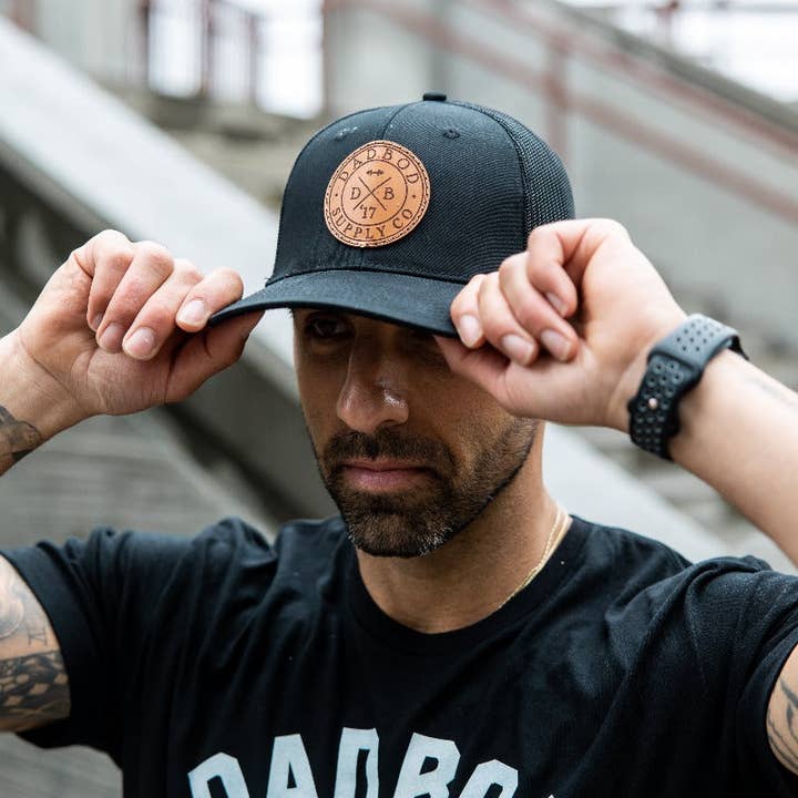 Dadbod Apparel - Wholesale Trucker hat – Men's - Leather Circle Logo Snap Back Black Mesh