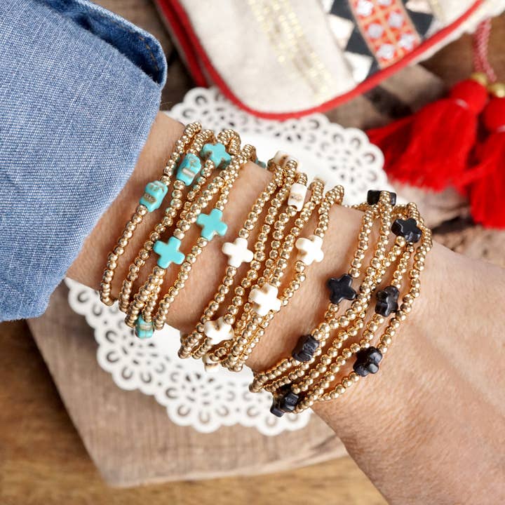 Mini-bracelet en forme de croix en pierre avec perles en forme de boule dorées, turquoise, noir et blanc pour la vente par PennyLine inc