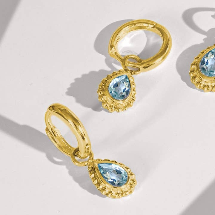March Birthstone Huggie Hoops - Gold Aquamarine for wholesale by Charlotte's Web Jewellery