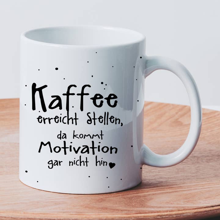 Ceramic mug with the saying "Coffee reaches places..." for wholesale by Farbrausch