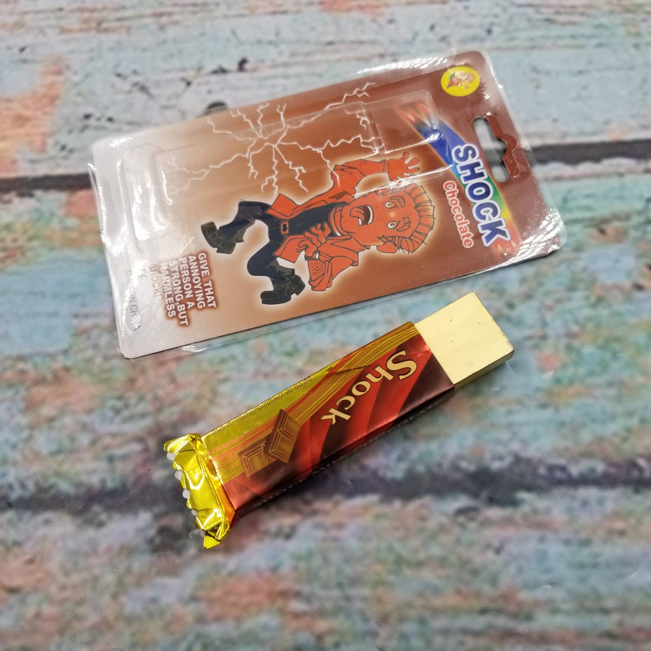 MIAS SHOP – wholesale Classic toy – Kids – Electric Shock Disguised Chocolate Pull Head Shocking Toy1