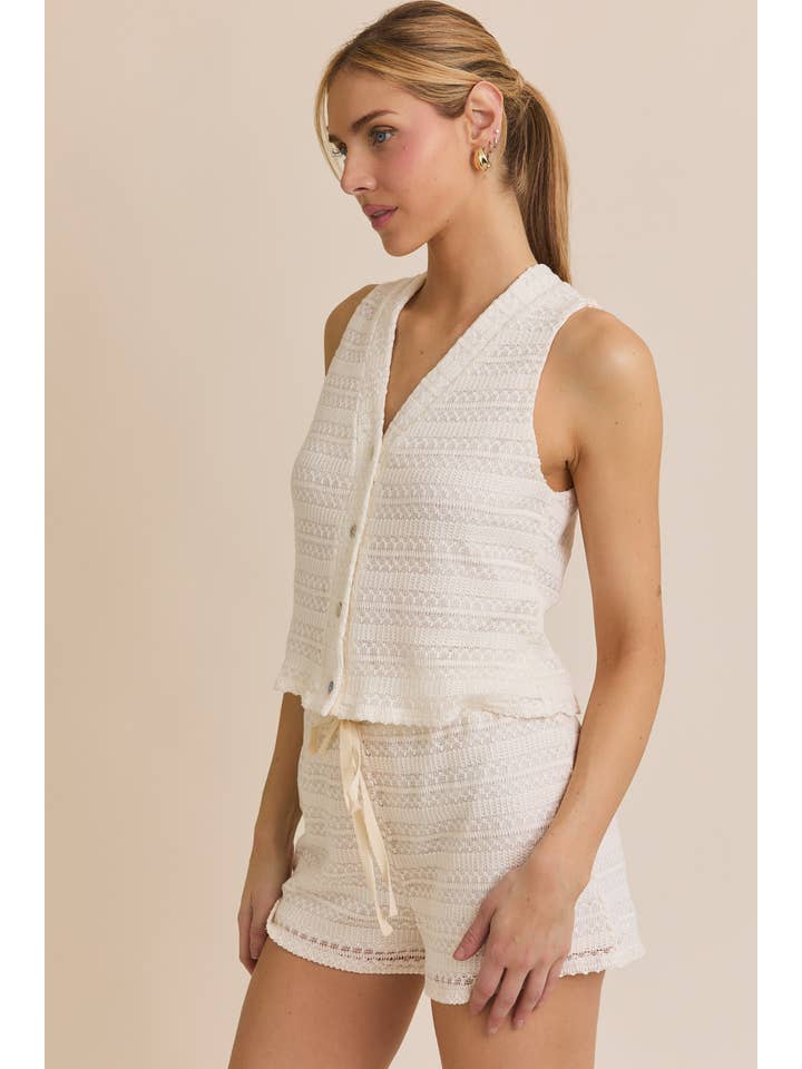 CREAM BUTTON UP SLEEVELESS CROCHET TOP AND WAIST TIE CROCHET SHORT for wholesale on Faire