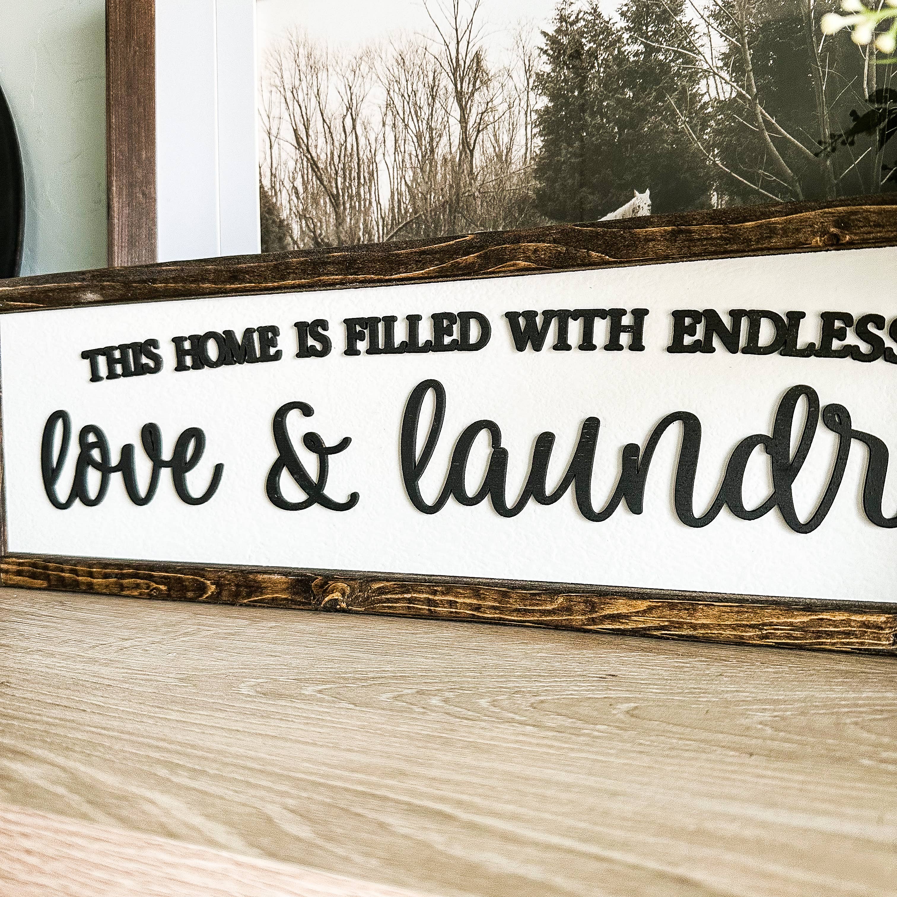 Dakota + Pine Design Co. – wholesale Sign – This Home Is Filled With Love And Laundry Sign1