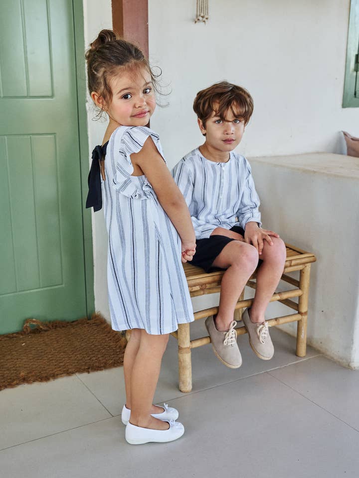 Girl's dress in two-tone stripes with a bow on the back for wholesale by Dadati