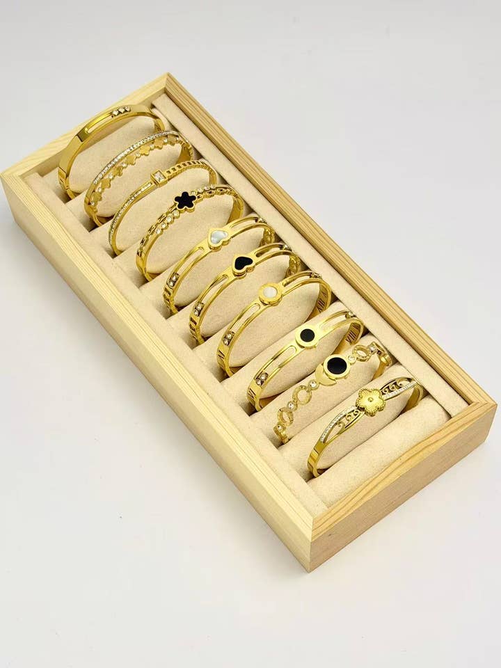 Set of 10 elegant stainless steel bracelets on display for wholesale by COSMOS