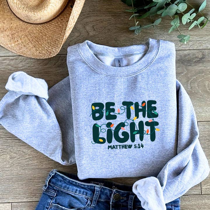 Be The Light - Christian Christmas Sweatshirt Matthew 5:14 for wholesale by God Influenced Apparel
