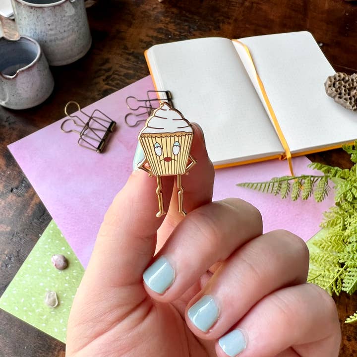 Vivian the VERY Vanilla Cupcake Enamel Pin (Miserable Food) for wholesale by The Unrefined Crafter