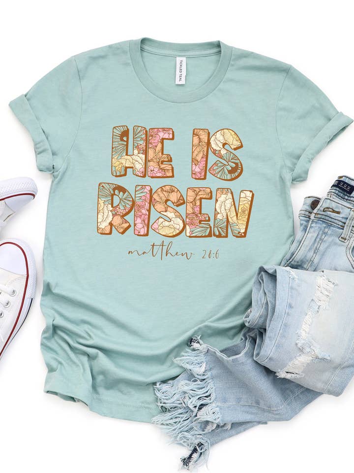Matthæus 28:6 Floral He is Risen Graphic Tee for engroshandel hos Tickled Teal