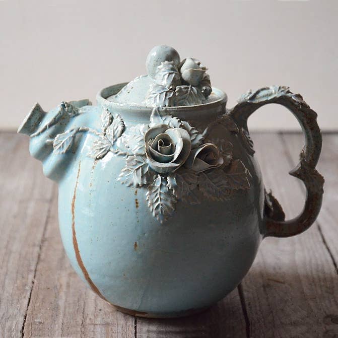"Alice in Wonderland" teapot - in granite blue glazed stoneware with rose vines for wholesale by L'Officina