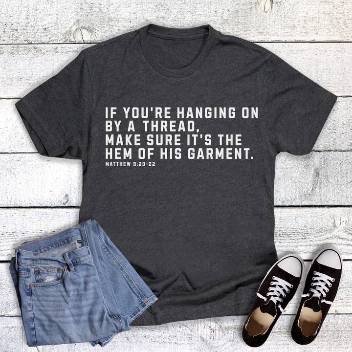 Faith Hanging by a Thread Hem of His Garment Graphic Tee for wholesale by Dust and Roots