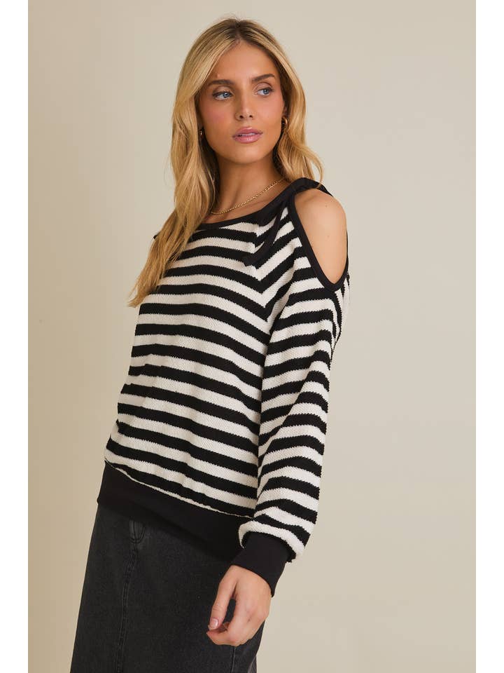 RAYURE BLANC-NOIR Haut à rayures à manches longues avec découpe à l'épaule et col rond. en vente sur Faire2