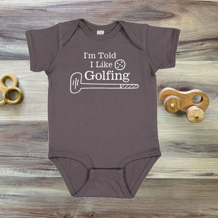 I'm Told I Like Golfing Silhouette Baby Bodysuit for wholesale by Rocket Bug