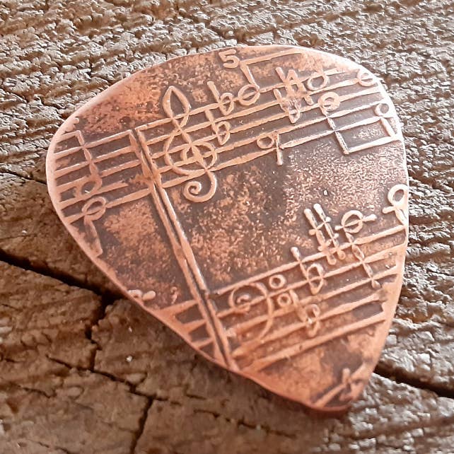 handmade and playable copper pick with music notes for wholesale by NiciArt LLC