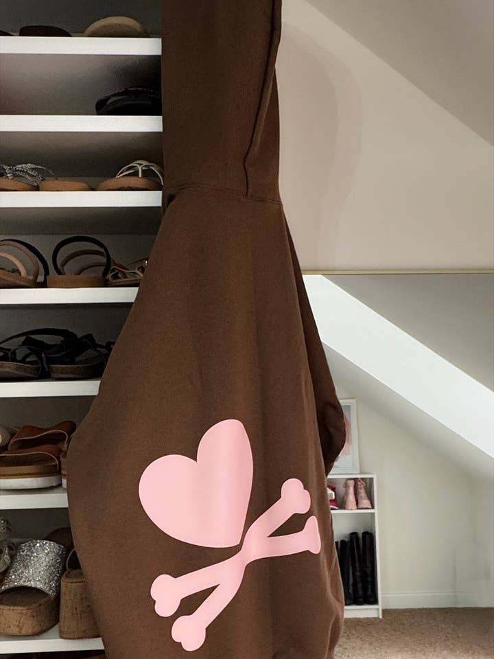 Sweet But Fearless Hoodie – Chocolate Pullover with Light Pink Heart & Crossbones Graphic for wholesale by The Maximalist Boutique