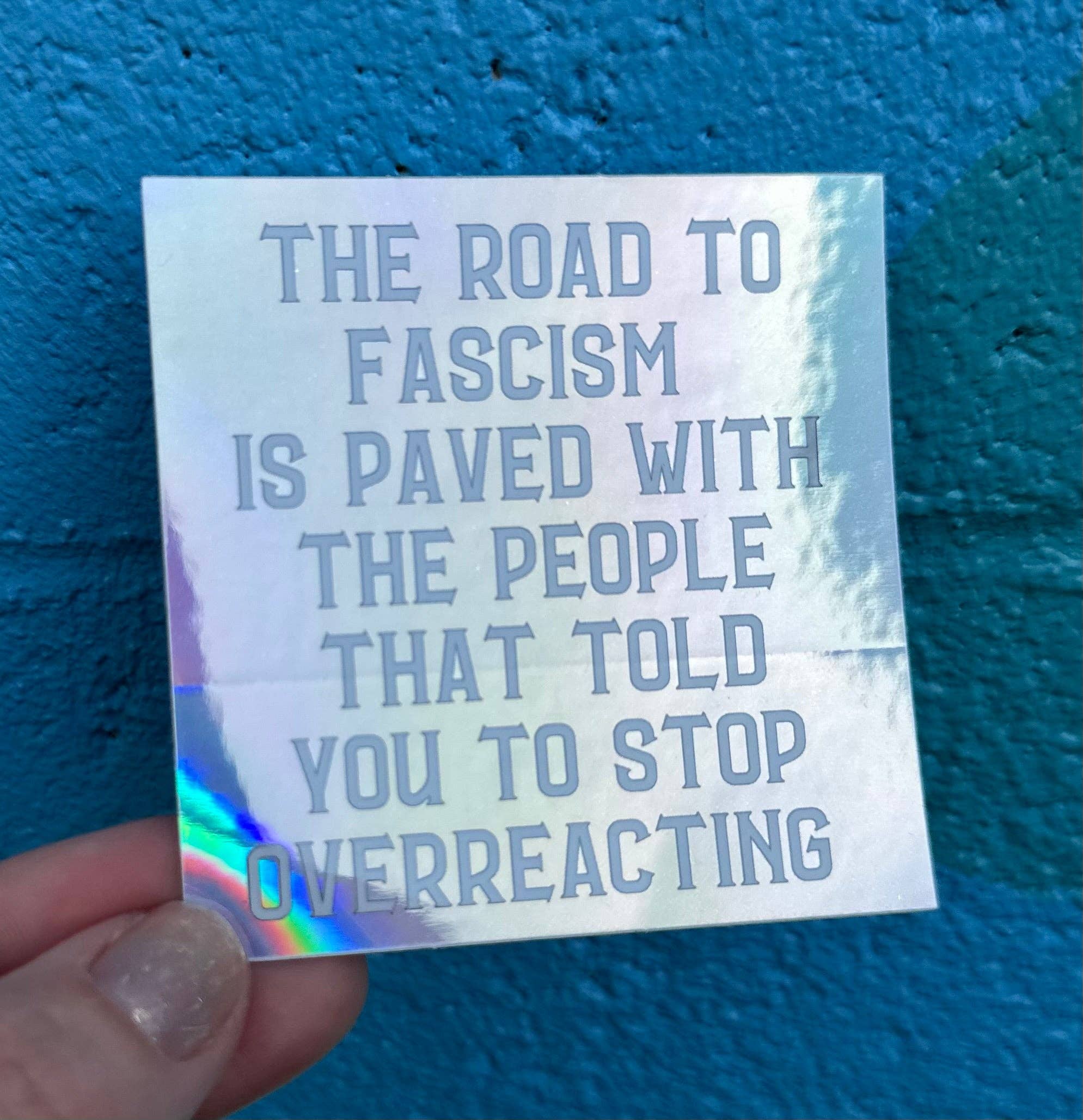 Hilarious Humanitarian - Wholesale Sticker - The Road To Fascism Is Paved With The People That Told You To Stop Overreacting Holographic Sticker0