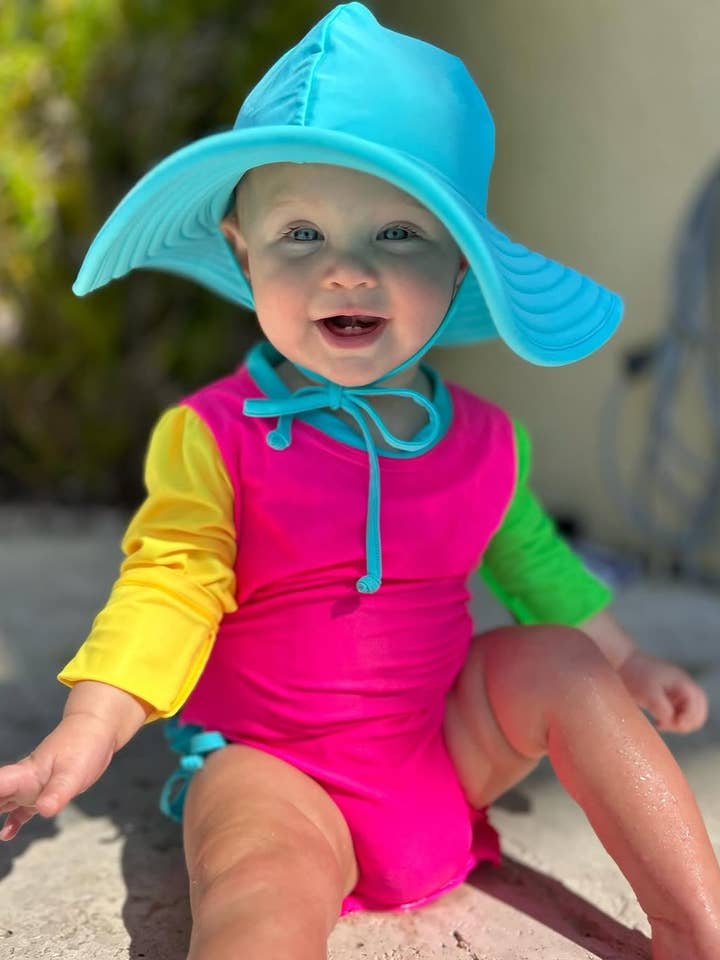 Baby Girls Neon Color Block Long Sleeve One Piece Rash Guard Swimsuit with Signature Rear Ruffles
for wholesale by RuffleButts + RuggedButts