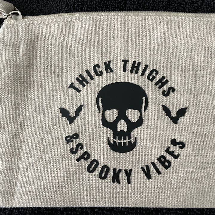 Thick Thighs and Spooky Vibes canvas pouch for wholesale by Itzlitwrite