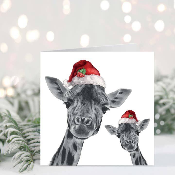 Carte de Noël Girafe et Bébé avec Chapeau Rouge Festif pour la vente par Libra Fine Arts