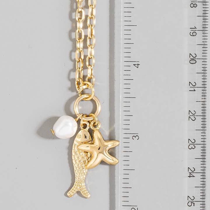 The Looks by Fame Accessories - Vente Colliers à pendentif - Collier avec pendentifs poisson, perle et étoile de mer2
