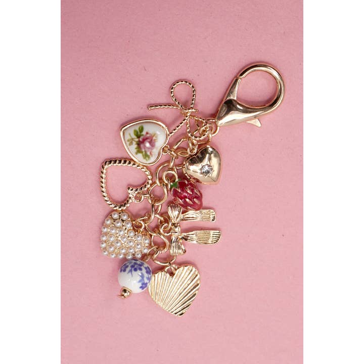 Gold PORCELAIN BOWS HEARTS PEARL STRAWBERRY BAG CHARM | 80K008 for wholesale on Faire