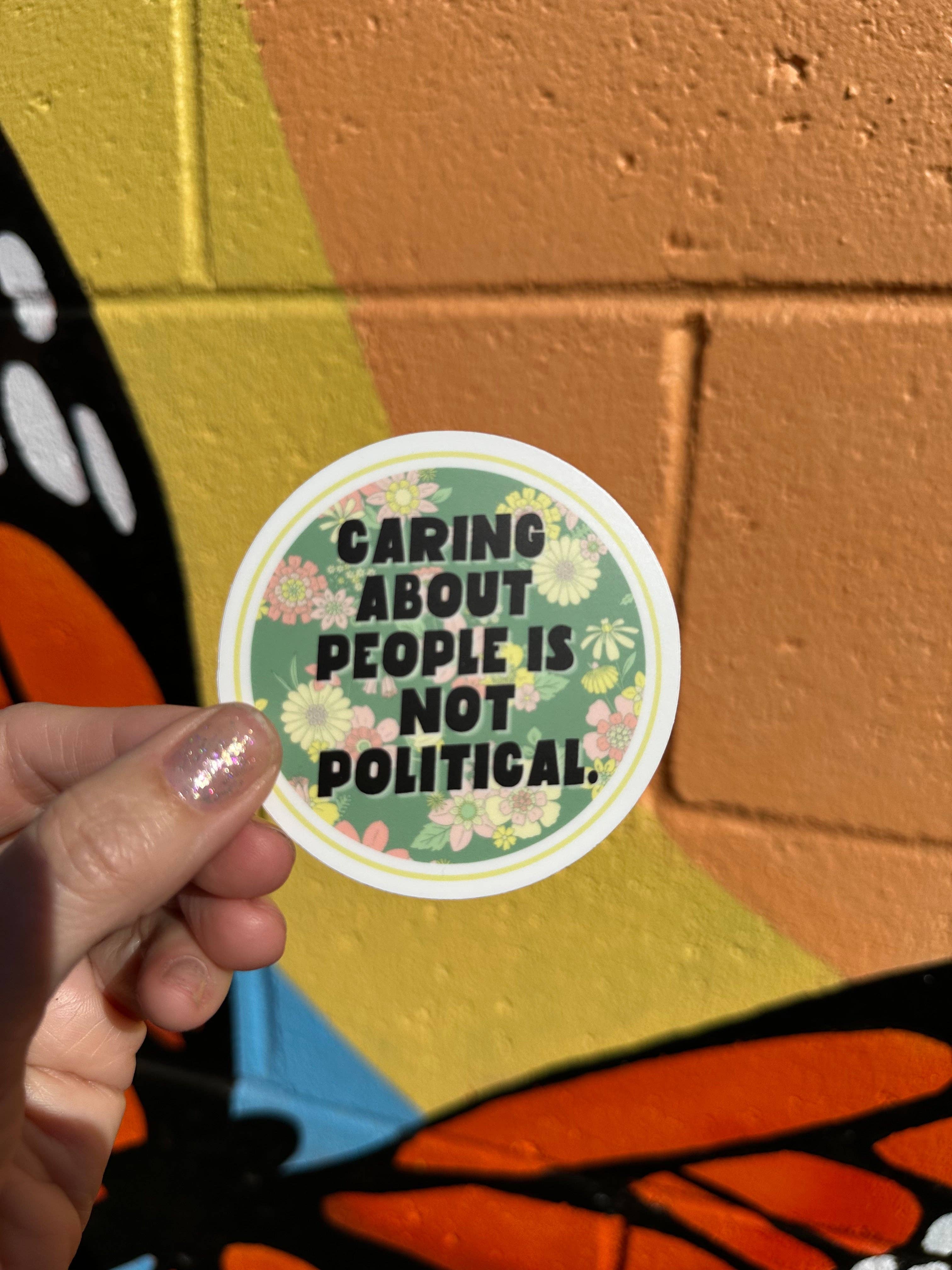 Hilarious Humanitarian - Wholesale Sticker - Caring About People Is Not Political Sticker1