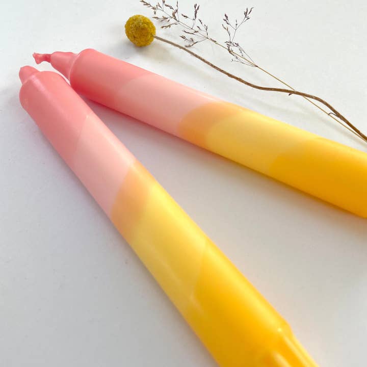Sherbert Pink & Amber Yellow Swirl Dip Dyed Dinner Candles for wholesale by The Singing Rabbit
